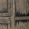 Close up of finish on Tall 'Hitchens' cabinet with worn black paint and two doors on a white background by Four hands furniture