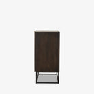 Kelby brown wood bar cabinet with carved doors and black iron frame base by four hands on a white background