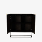 Kelby brown wood bar cabinet with carved doors and black iron frame base by four hands on a white background