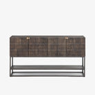 Four hands furniture brand Kelby media console with iron base and four carved doors with square brass pulls on a white background