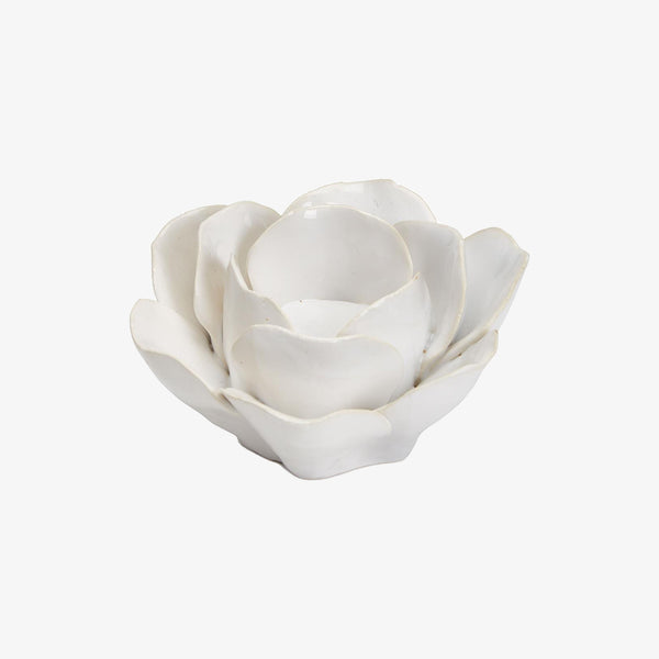 white flower shaped tea light holder on a white background