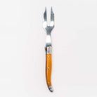 Orange Laguiole cheese fork on a white background