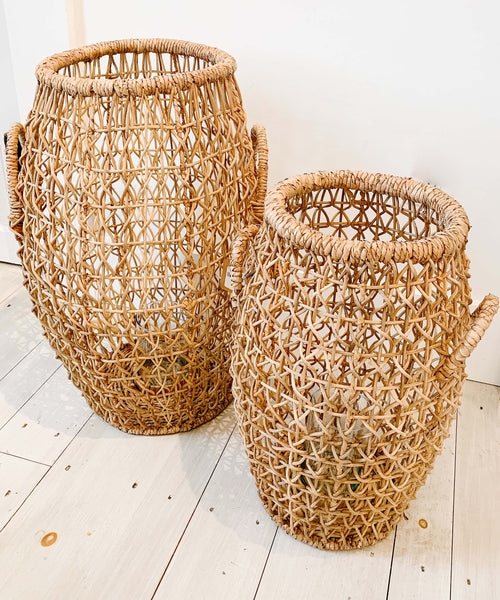 Oversized seagrass lantern on a whitewashed wood floor