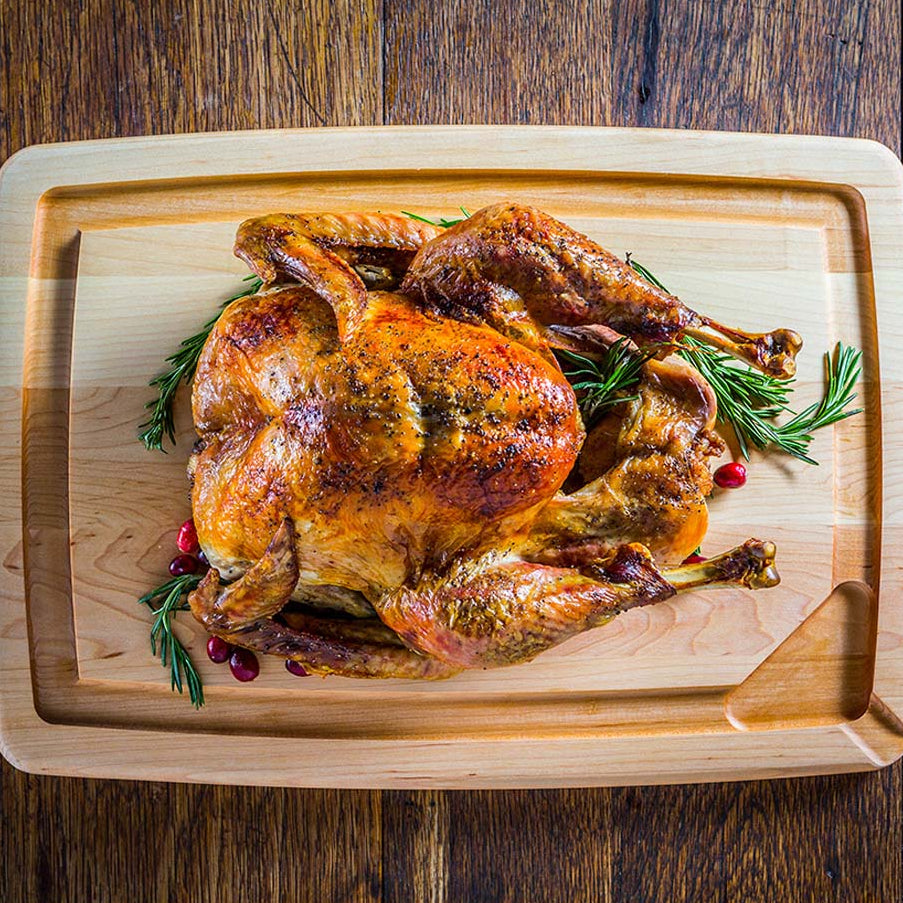 JK Adams pour spout maple carving board with chicken on top