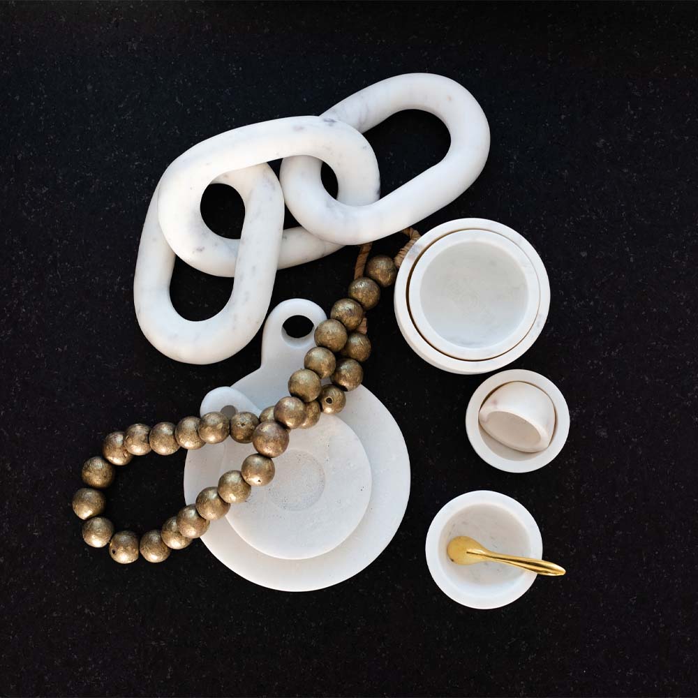 Collection of white marble decorative objects on a black background