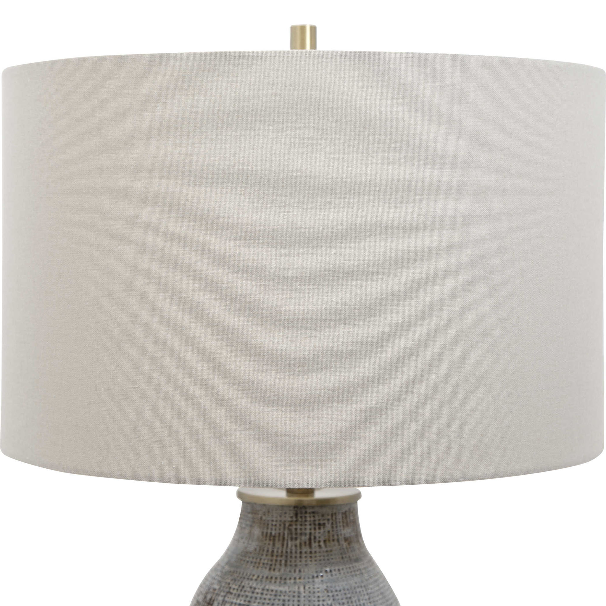 Close up of Moynahan Table Lamp on an end table in a living room at Addison West on a white background at Addison West