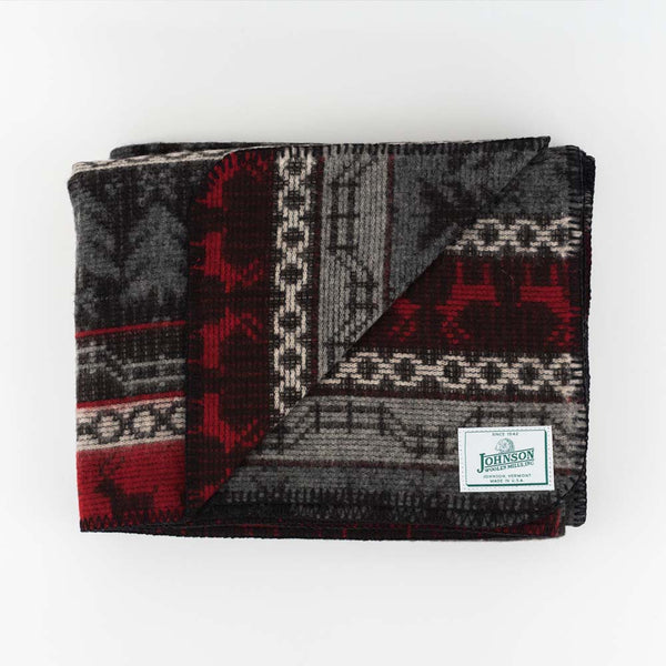 Johnson Woolen Mills wool blanket in grey and red with holiday reindeer print on a white background