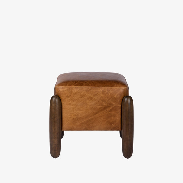 Square leather 'Oaklynn' ottoman by four hands furniture with oversized round wood legs on a white background