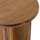 Stained acacia wood round end table with two rounded legs by four hands furniture on a white background
