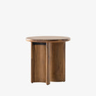 Stained acacia wood round end table with two rounded legs by four hands furniture on a white background