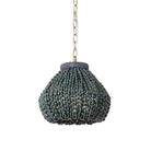 Palecek Amaya beaded pended with indigo palm-seeds and antique brass chain on a white background