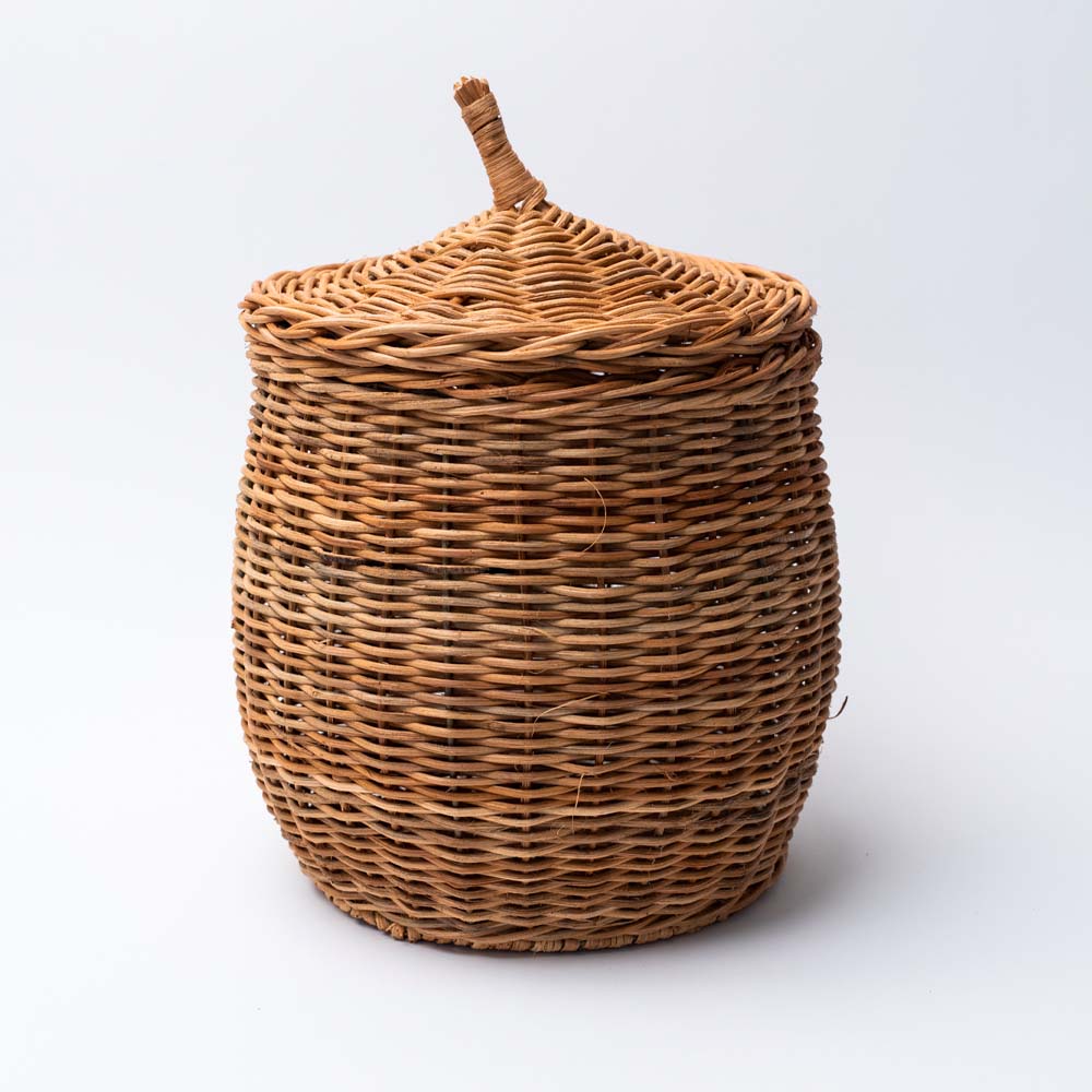 Large Natural wicker basket with lid on a white background