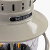 Close up of label and top on Barebones vintage white railroad lantern on a white background