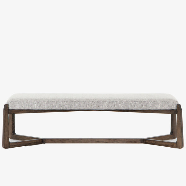 White upholstered 'Roscoe' bench with cross brace wood frame by four hands furniture on a white background