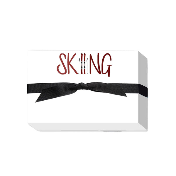 White note pad with skiing written across top in red
