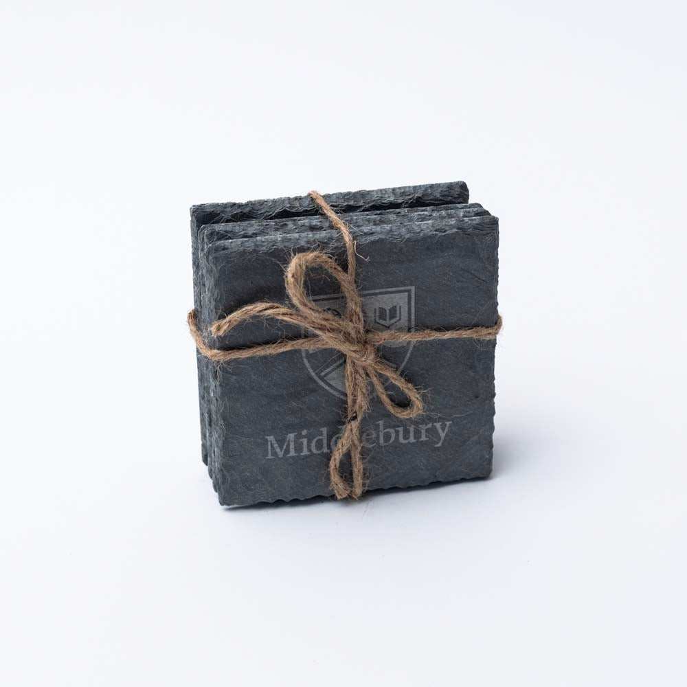 Set of four square slate Middlebury College coasters tied together with natural twine on a white background