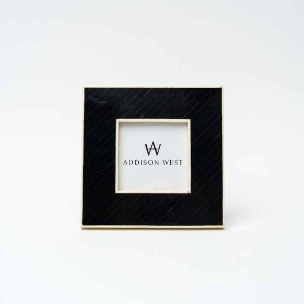 Black square photo frame for 4"x4" photo on a white background