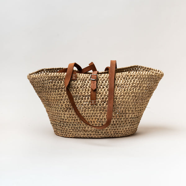 Straw French market bag with open weave long leather strap and buckle closure