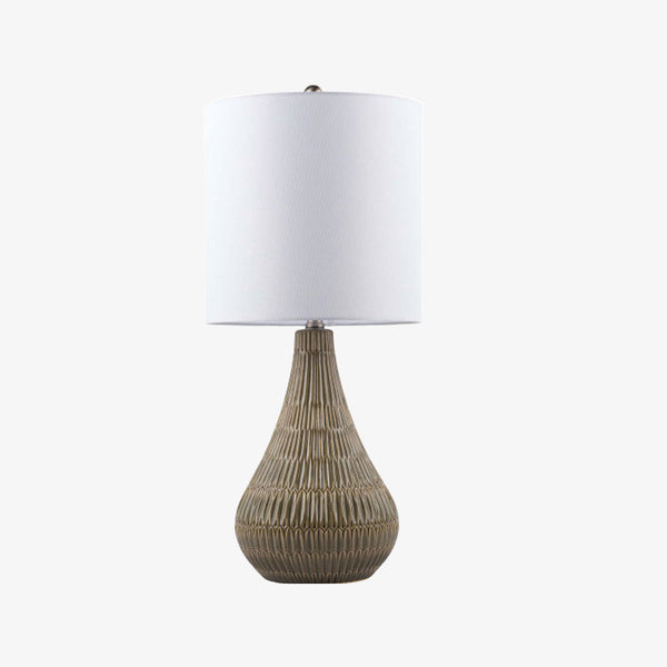 Gray glazed ceramic table lamp with white linen shade on a white background