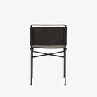Back view of Four hands brand wharton chair with black iron frame and black leather seat on a white background