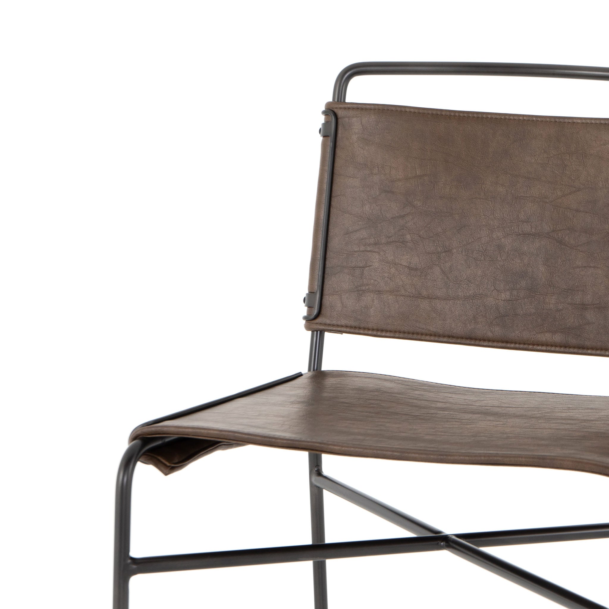 Close up of Four hands brand wharton chair with black iron frame and dark brown leather seat on a white background