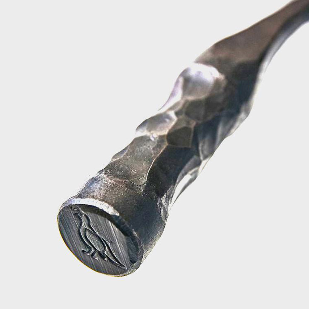 Close up of engraved mark on handle of Smithey farmhouse carbon steep skillet on a white background