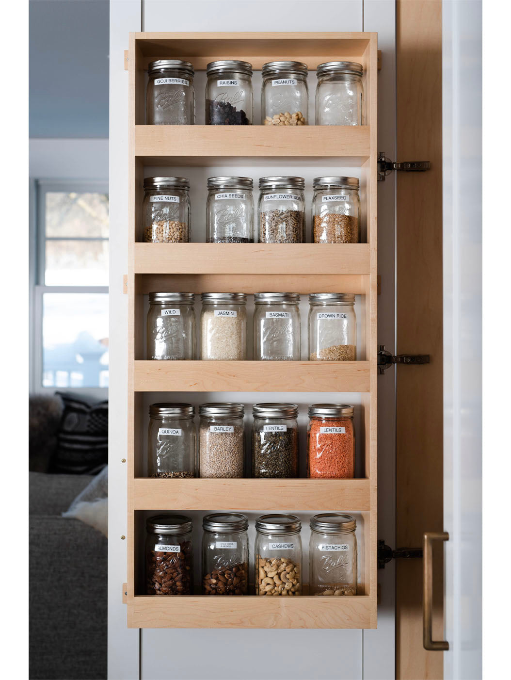 White kitchen with concrete counters and brass water stone faucets
