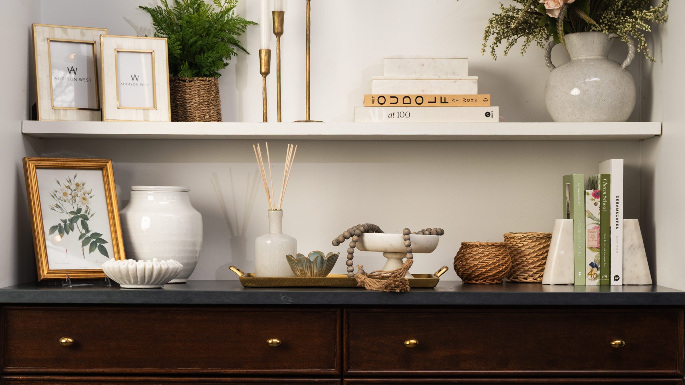 White shelves styled with white and neutral decor at Addison West