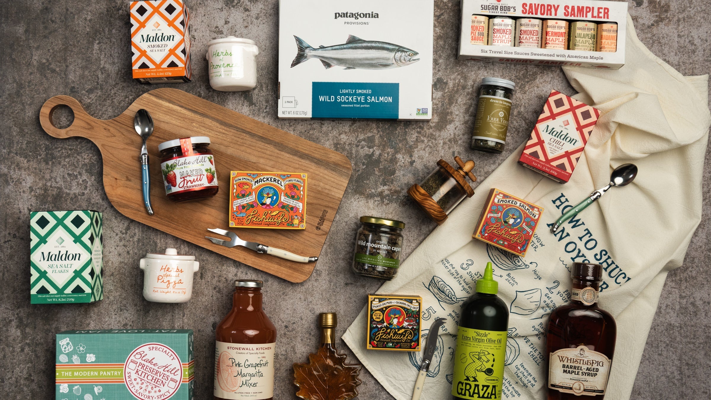 Collection of pantry goods on a grey background at Addison West