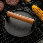 Smashburger Grill Press on a grill at Addison West