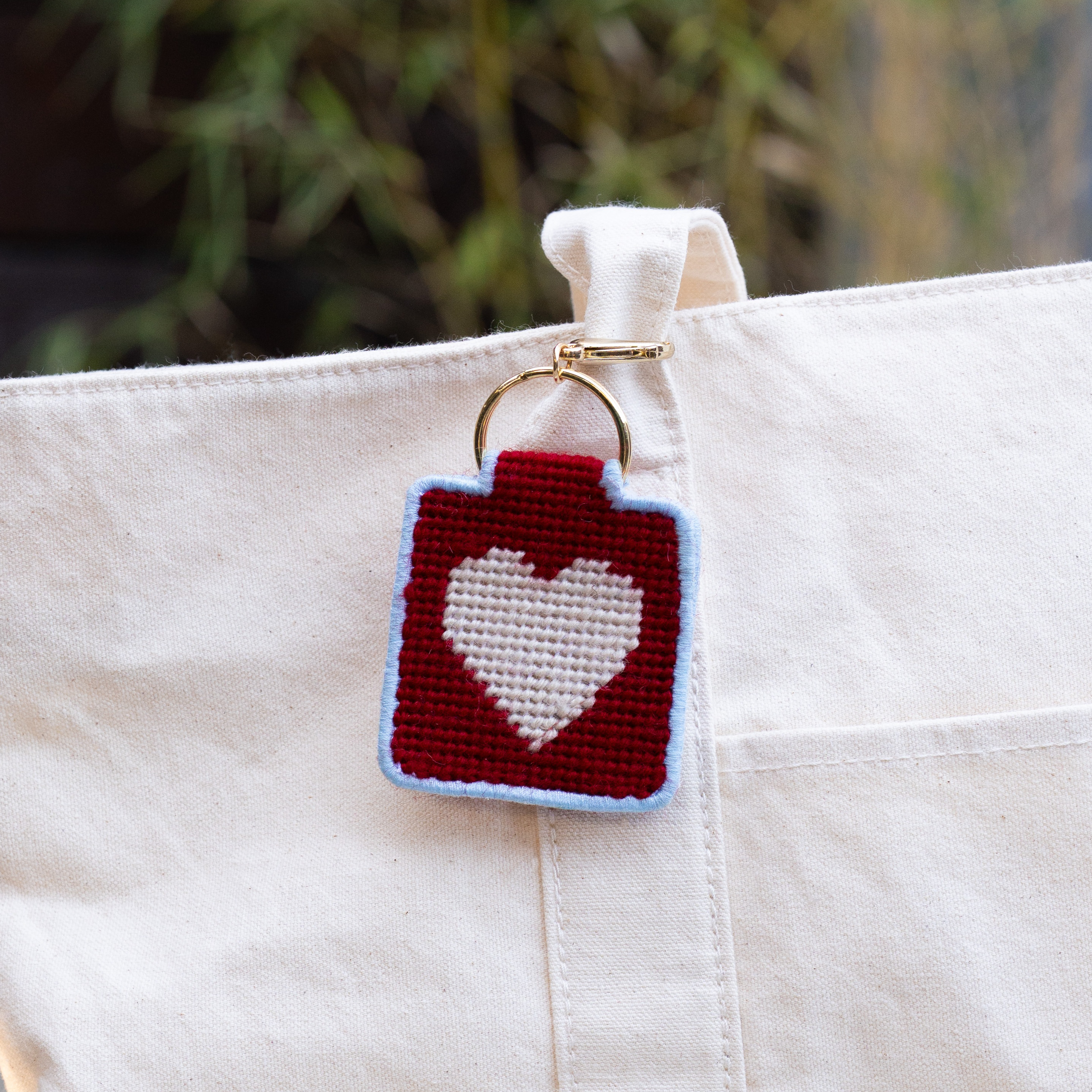Heart Needlepoint Keychain Kit on a bag at Addison West