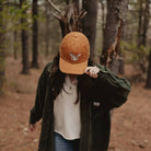 Barn Owl Corduroy Hat in Amber on a model outside at Addison West