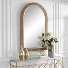 Capridge Arch Accent Mirror on a white wall above a table at Addison West