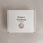 Knitting Craft Kit: Classic Pom Beanie in Pebbled Beach on a beige background at Addison West