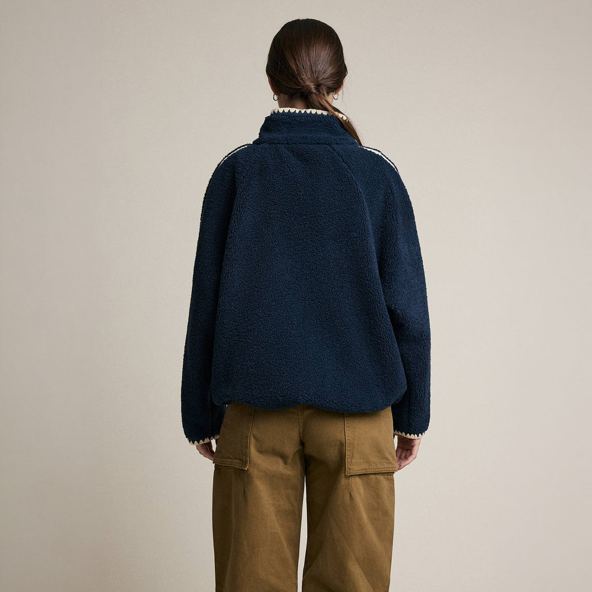 Contrast Trim Sherpa Zip-Up Jacket in Navy on a model at Addison West