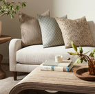 Mira Ocra Pillow 22" on a white background at Addison West on a sofa at Addison West