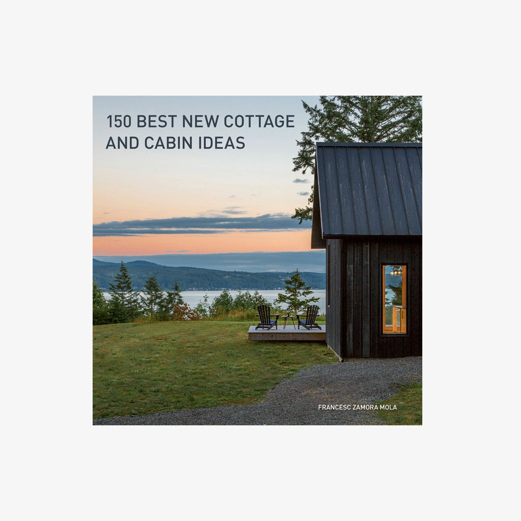 Front cover of book titled '150 Best New Cottage and Cabin Ideas' showing a cabin with a lake in the distance on a white background