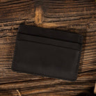 Leather Card Holder Wallet in Black on a table at Addison West