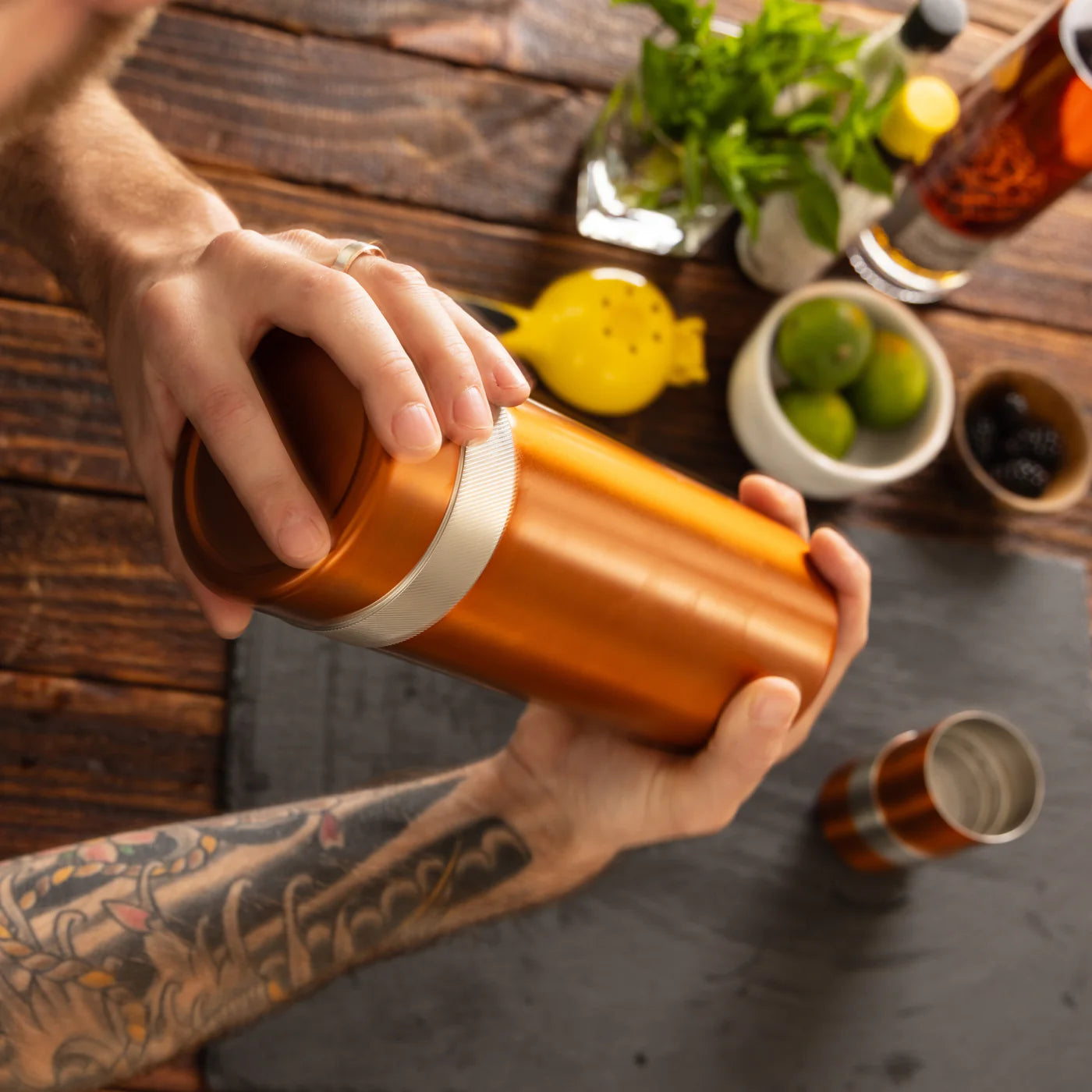 High Camp Highball Shaker in Copper with a model at Addison West