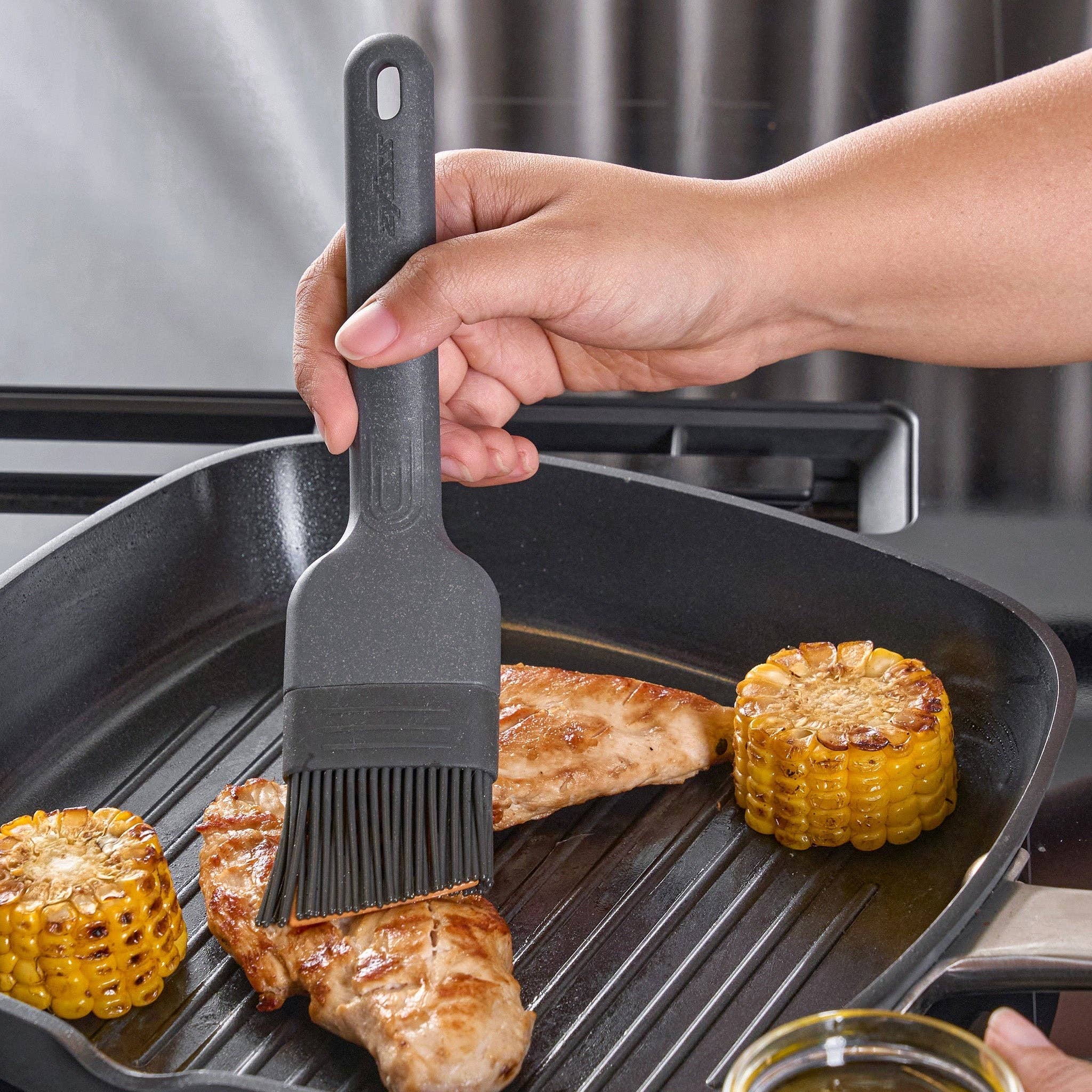 Silicone Basting Brush being used by a chef at Addison West
