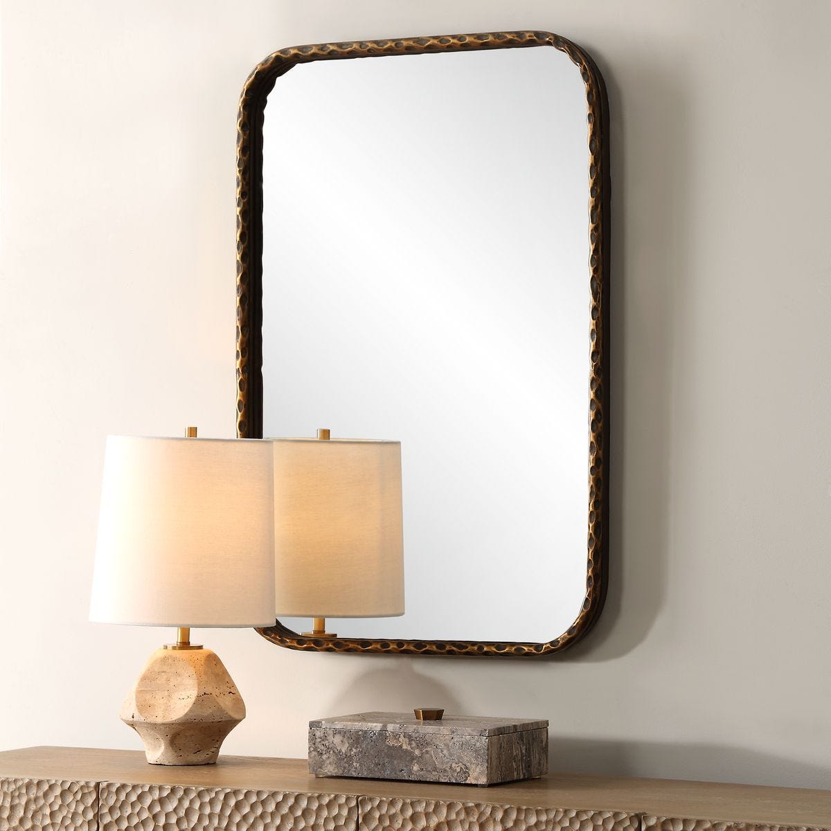 Knoxley Vanity Accent Mirror on a beige wall above a table at Addison West