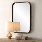 Knoxley Vanity Accent Mirror on a beige wall above a table at Addison West