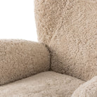 Four Hands Amelie Swivel Recliner in Beige Shearling on a white background at Addison West