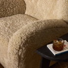 Four Hands Amelie Swivel Recliner in Beige Shearling in a living room at Addison West