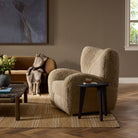 Four Hands Amelie Swivel Recliner in Beige Shearling in a living room at Addison West