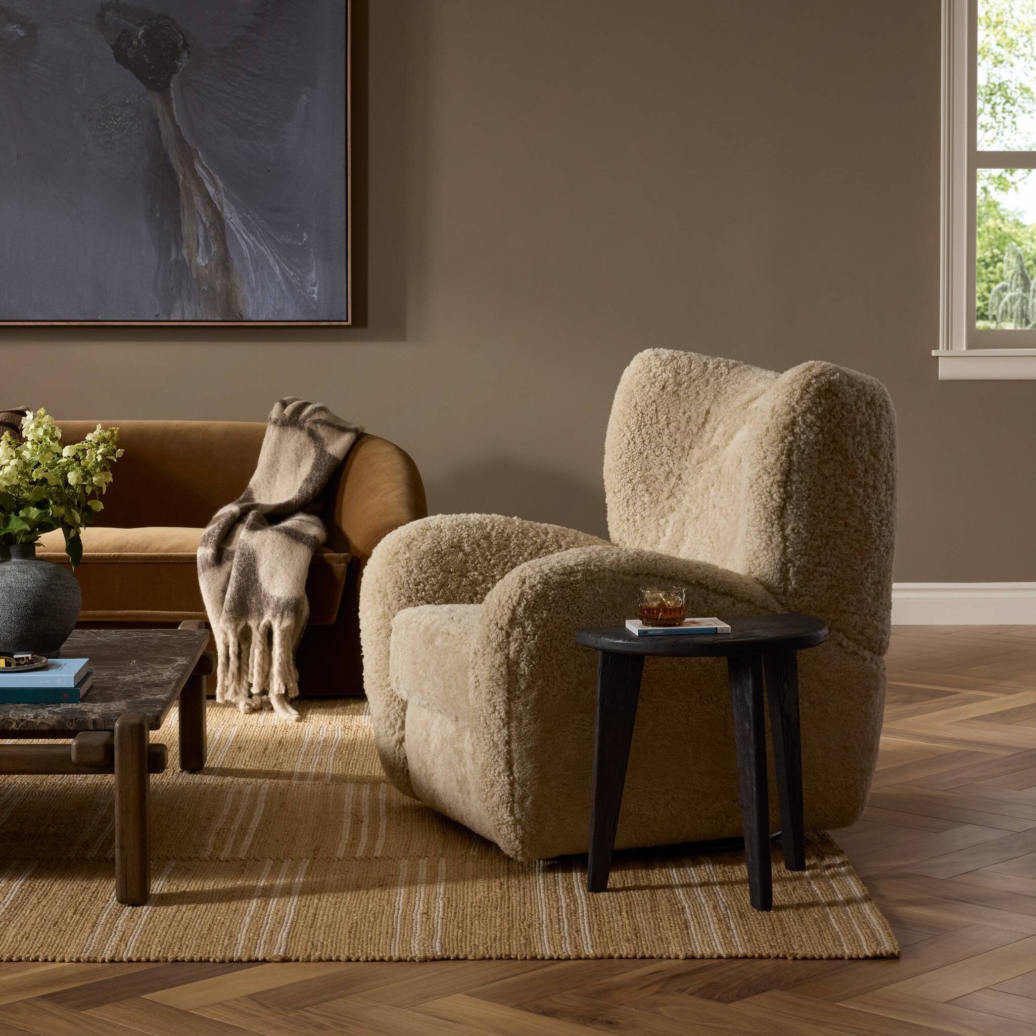 Four Hands Amelie Swivel Recliner in Beige Shearling in a living room at Addison West