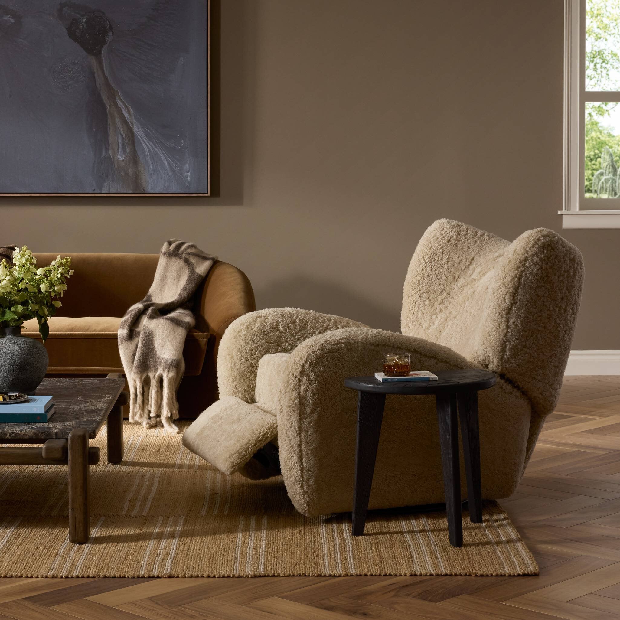 Four Hands Amelie Swivel Recliner in Beige Shearling in a living room at Addison West