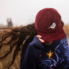 Chickadee Corduroy Hat in Merlot on a model outside at Addison West