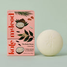 Tonka Bean & Coconut Deep Moisturizing Lotion Bar on a blue background at Addison West