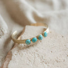 Commonform Bridger Cuff in Turquoise on textured background at the Addison West.